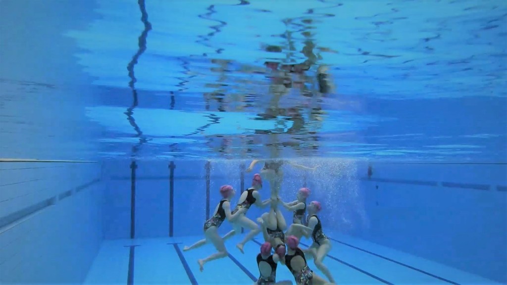 An underwater view of Edinburgh Synchro swimmers performing a lift - without touching the floor!